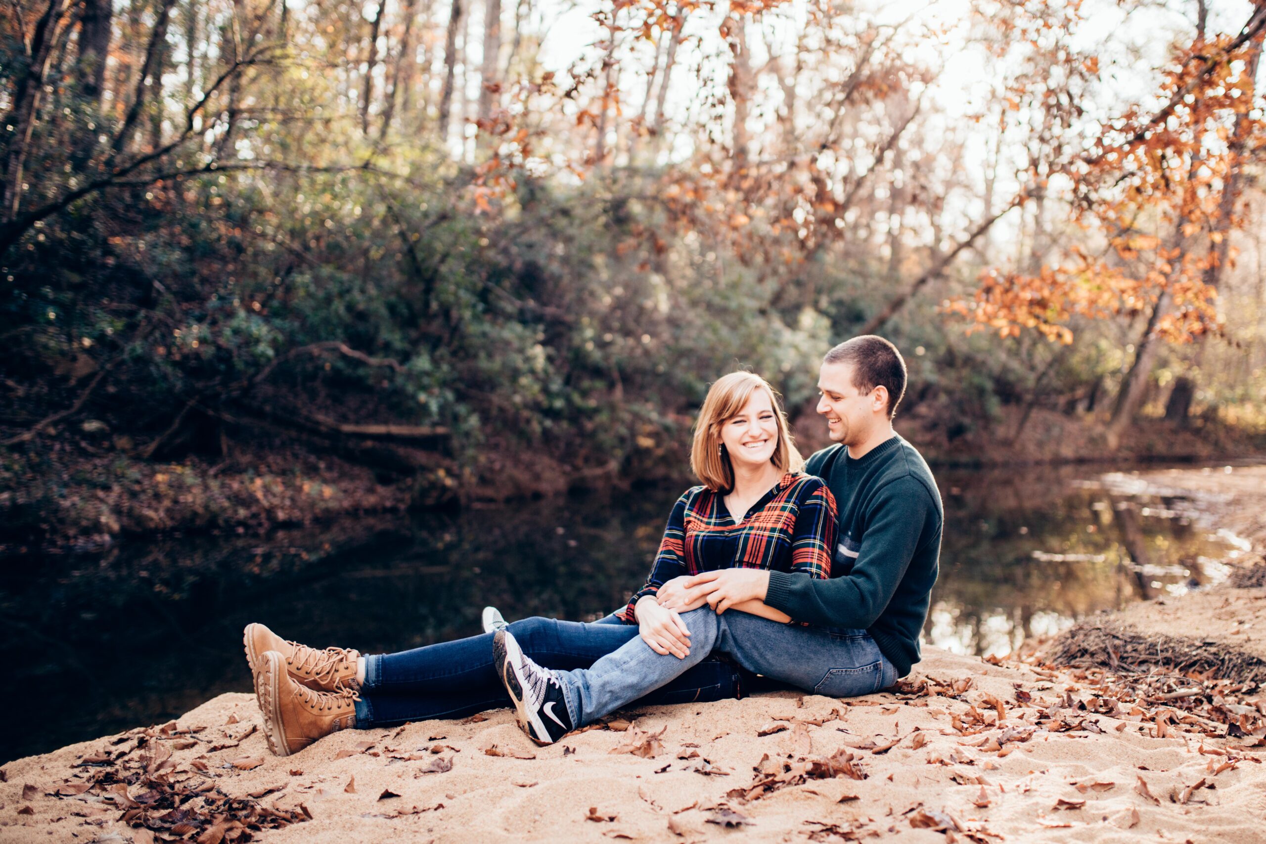 couple out hiking by a stream