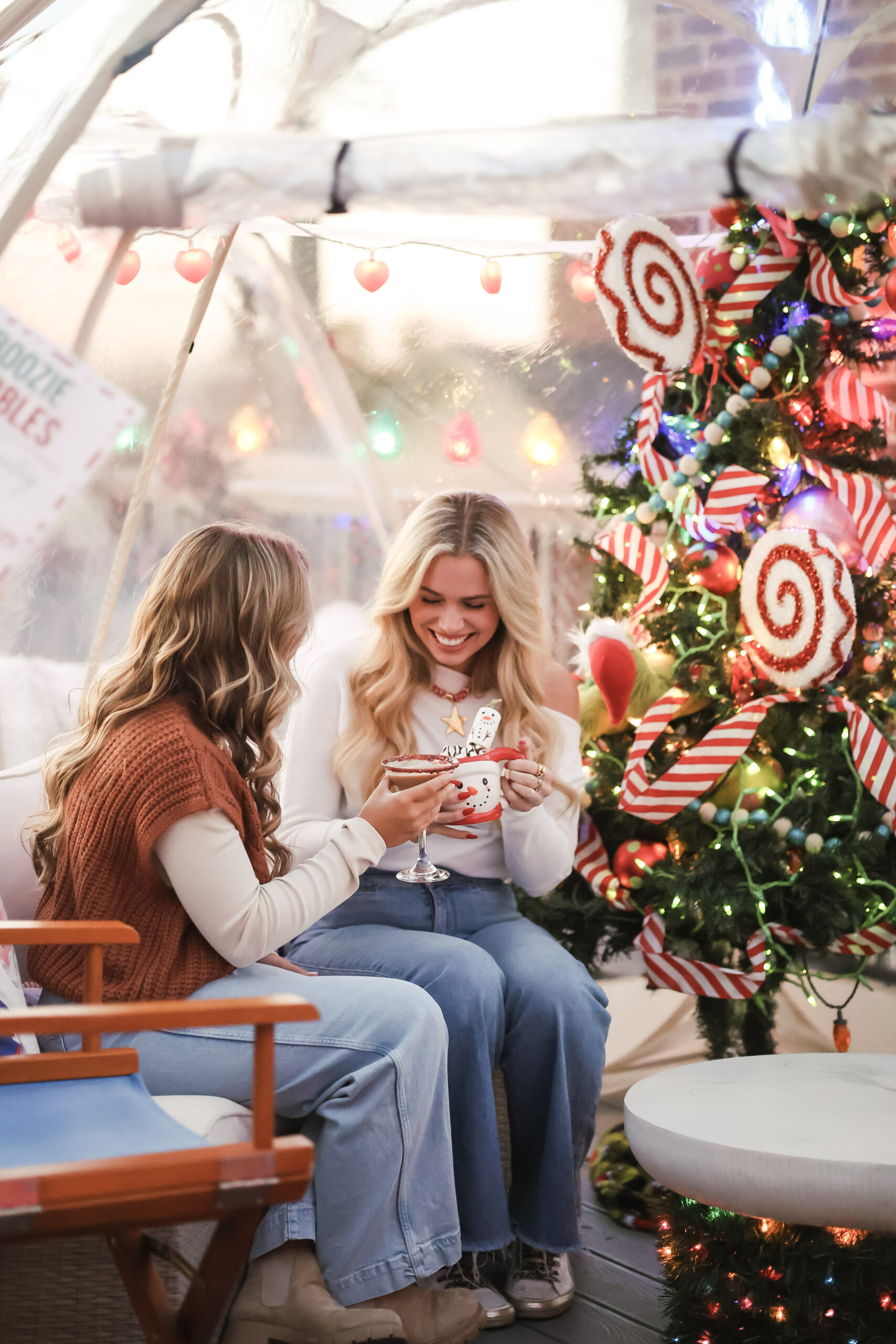 Friends enjoying holiday drinks inside a Boozie Bubble