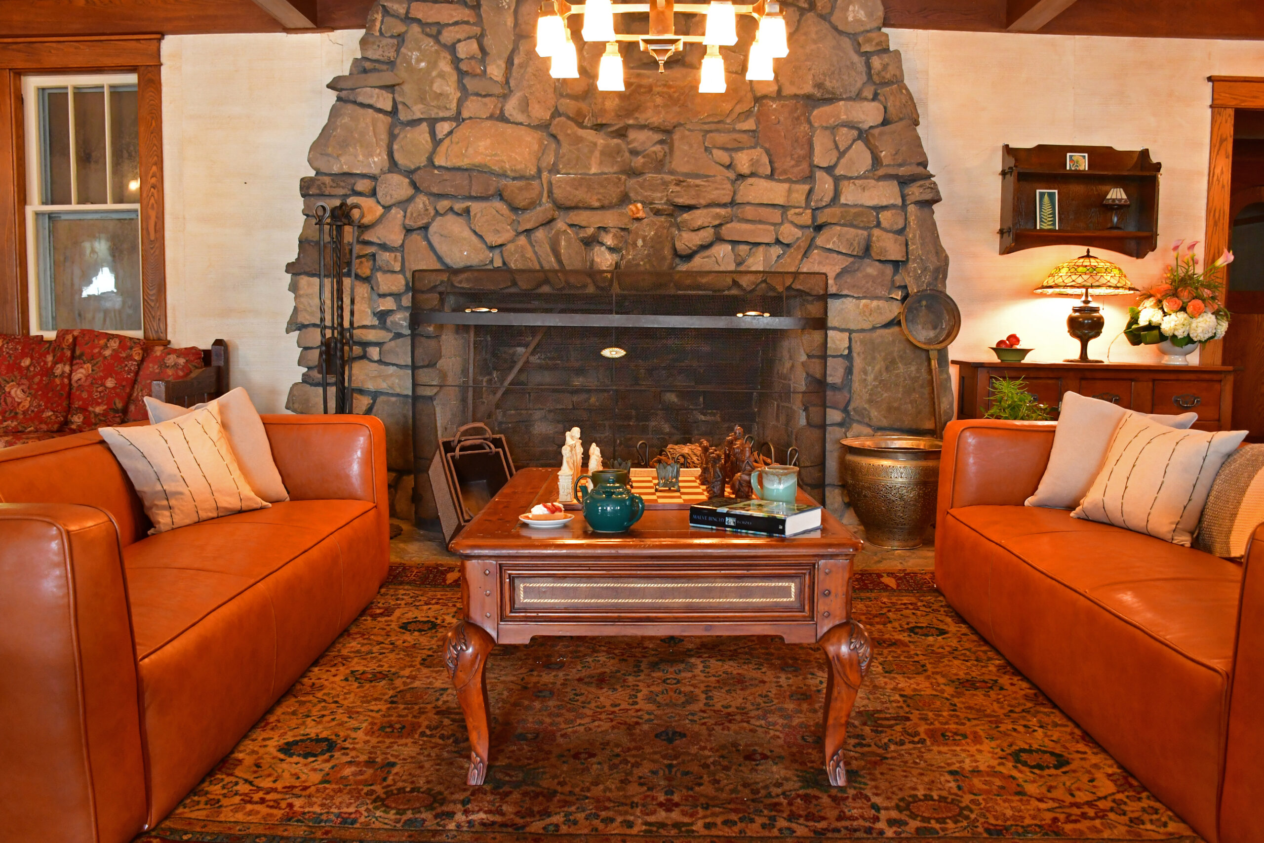 lounge space with couches and stone fireplace