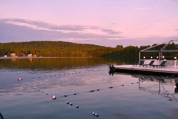 view of a dock overlooking the lake at dusk