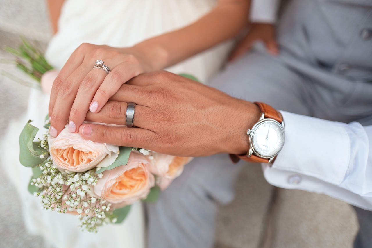 bride and groom with wedding bands