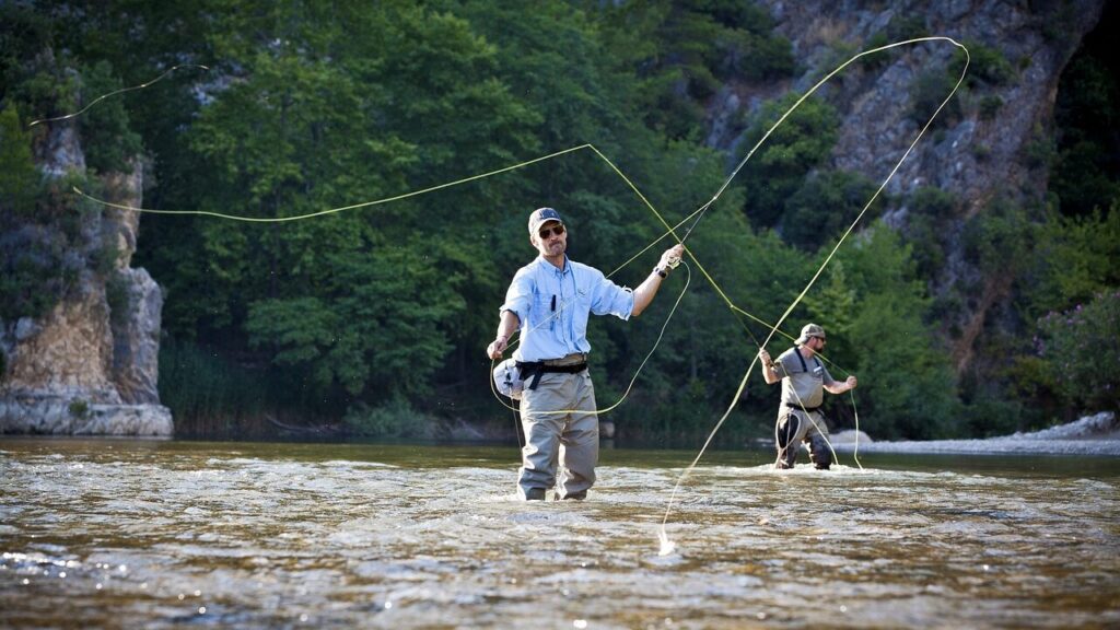 two men fly fishing in the river