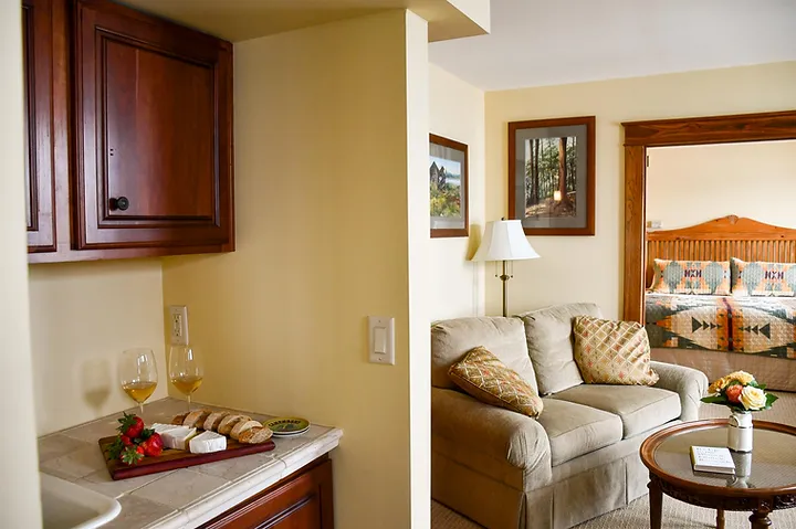 view of the lakeview king suite, featuring a sitting area and a cheeseboard and two glasses of wine