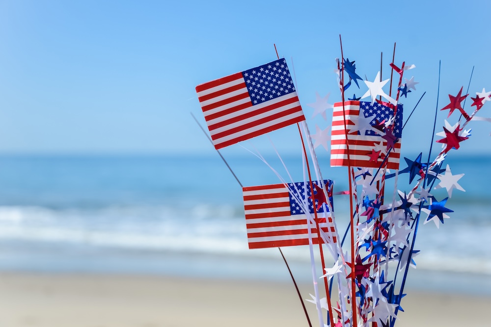 American flags on beach in sand