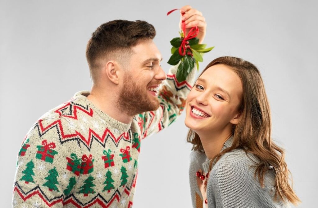 couple leaning in for kiss under mistletoe