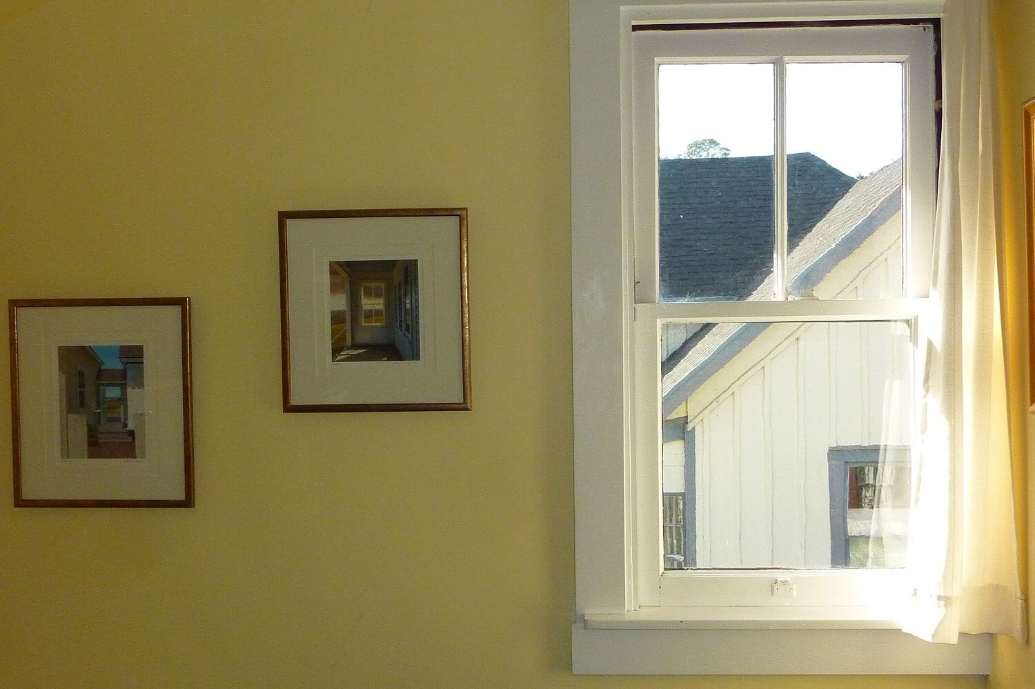 Aloft room west window with two framed photos