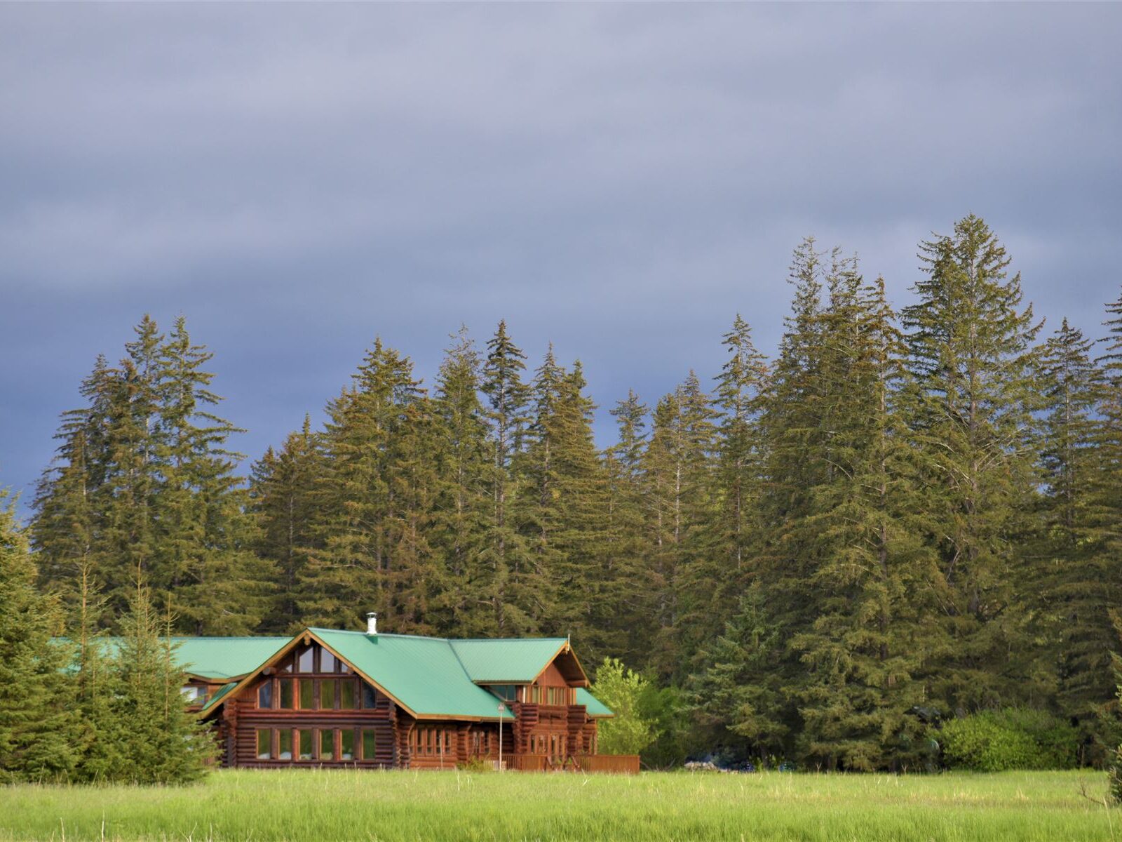 Bear Track Inn across a meadow and nestled in trees