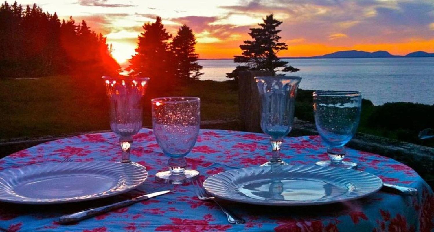 Great Duck Island House | Porch table setting and sunset beyond