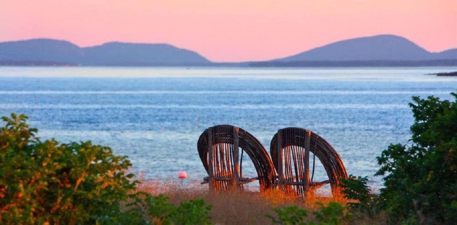 Great Duck Island House | Chairs on the shoreline and the view beyond