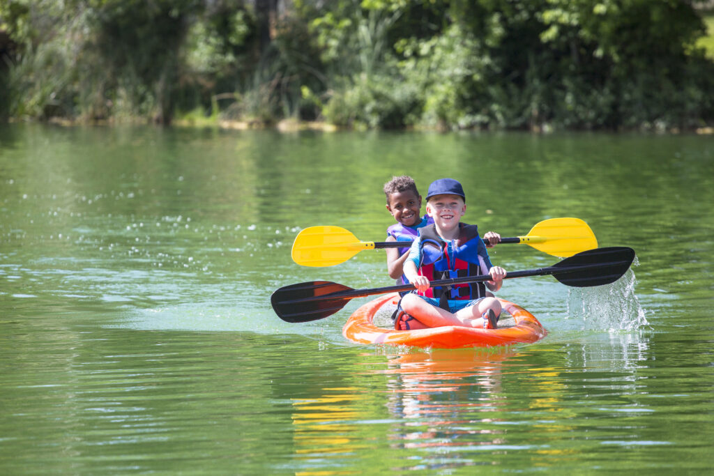 Boys kayaking on the lake.