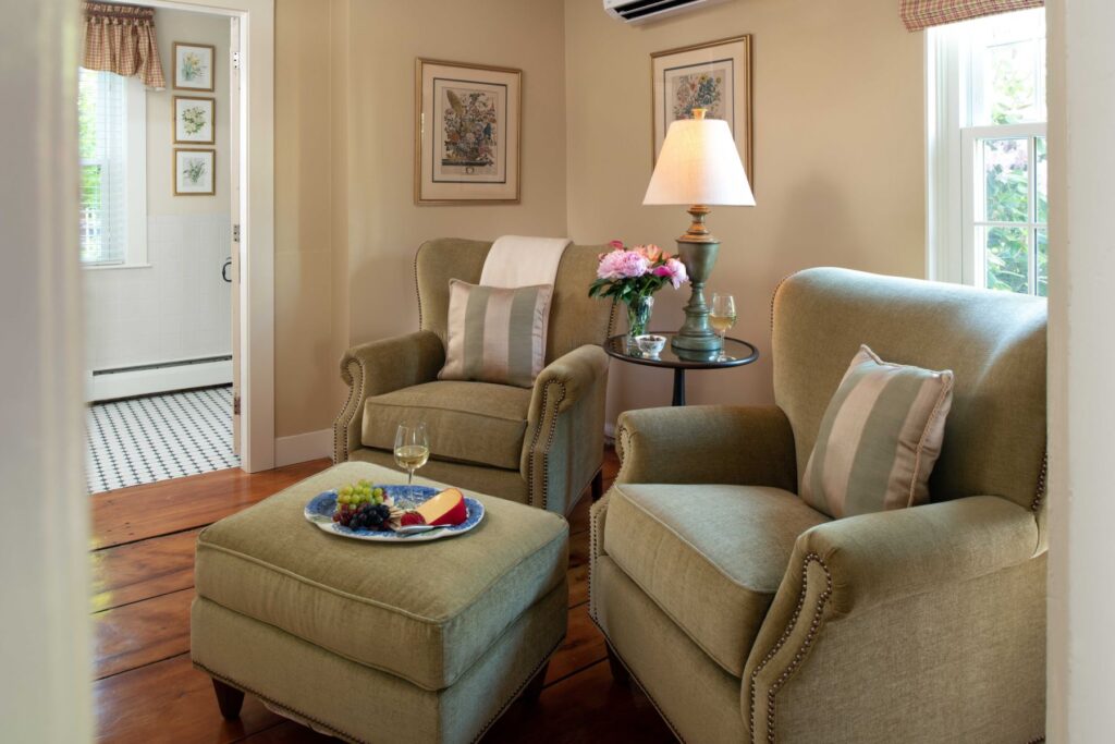A section of the seating area with olive green chairs in The Wellfleet Room at The Inn at Yarmouth Port