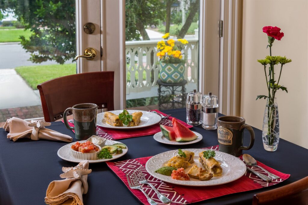 Breakfast plated for two on a dressed table at The Addison on Amelia Island