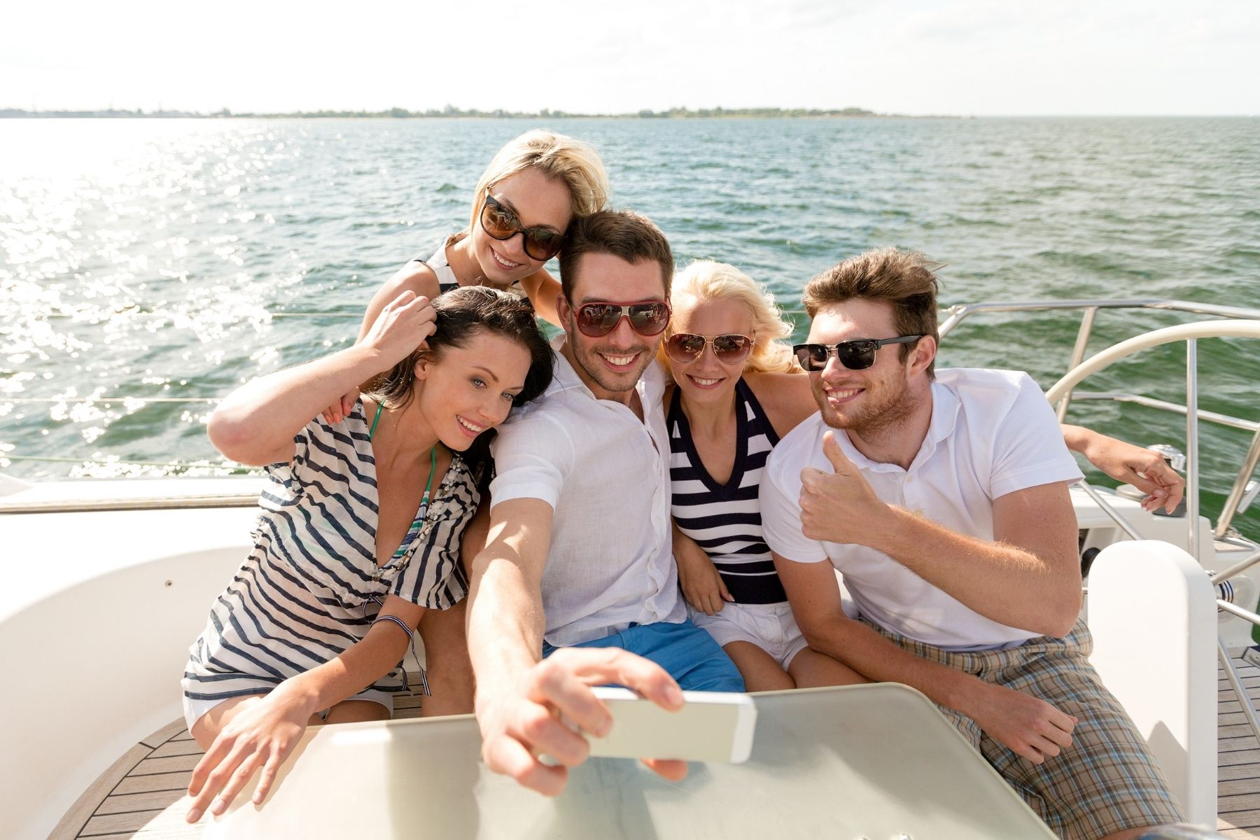 group of friends taking a selfie on a boat tour