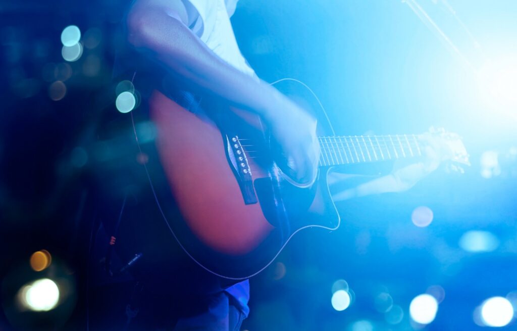 Person playing live music on Amelia Island at a local eatery.