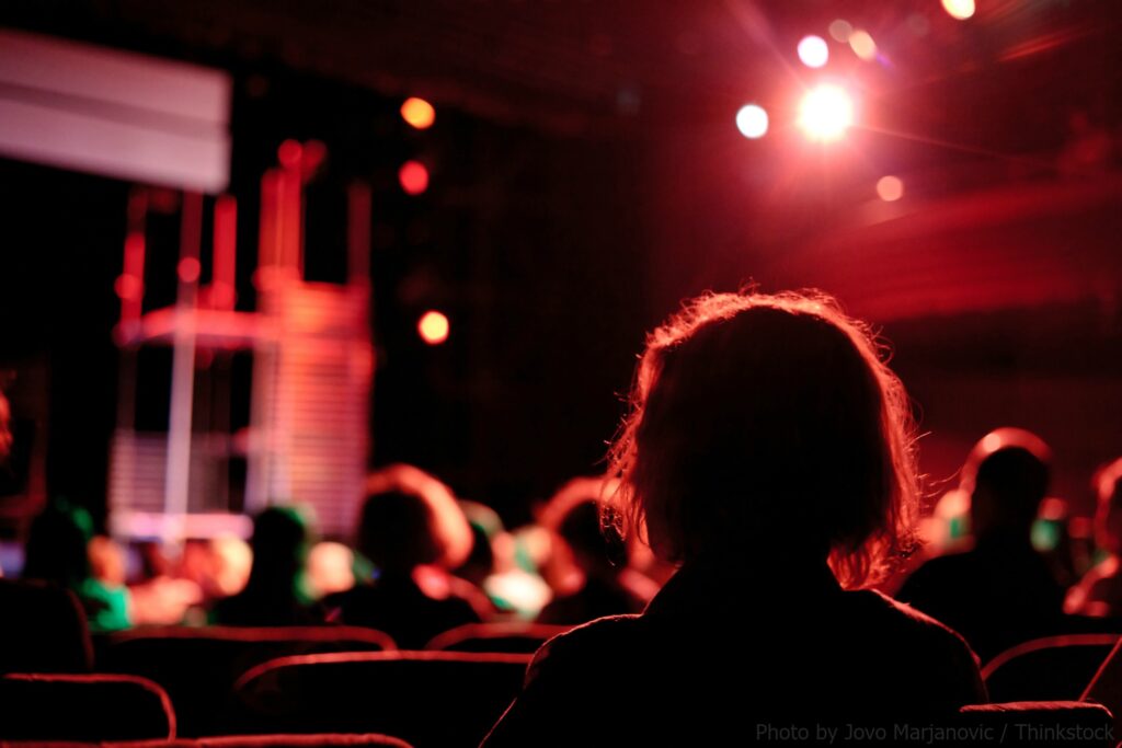 person watching show at theatre