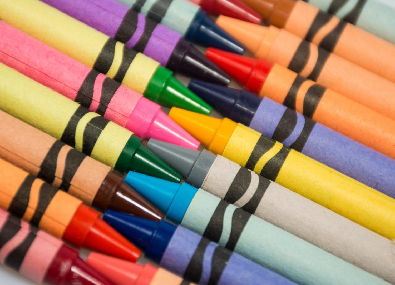 Closeup of multuplie colored crayons on a diagonal array