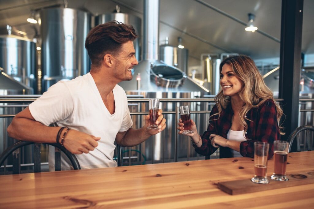Couple at brewery toasting beers