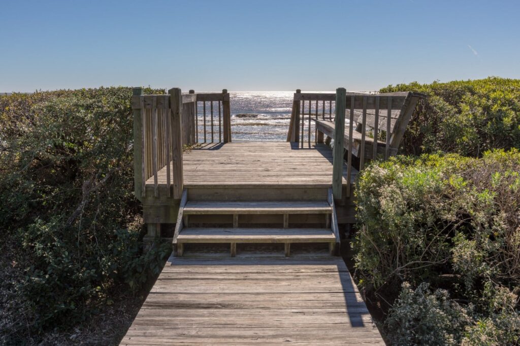 View of private wooden pathway to beach