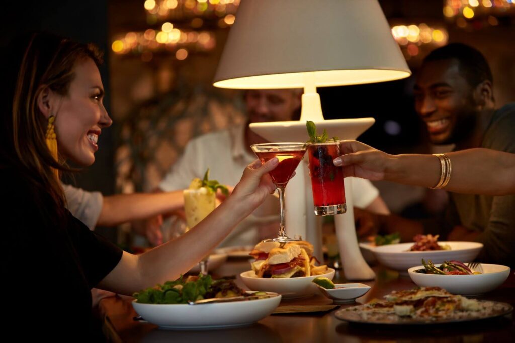 Friends Doing a Cheers at Dinner with their Drinks