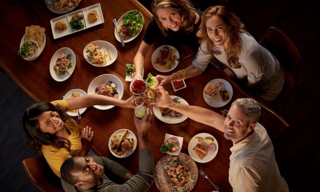 Overhead Photo of Friends Enjoying Dinner and Drinks