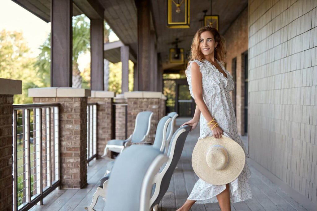 Woman Posing on Porch with Sun Hat