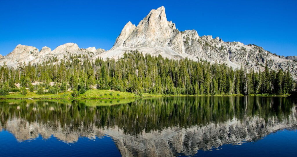 a mountain peak behind a lake