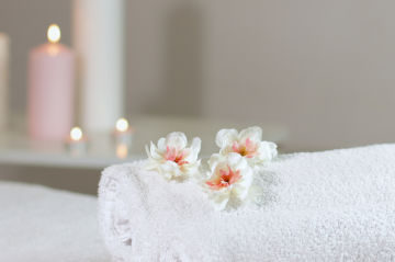 Flowers on a white towel with candles in background