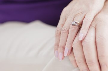 Close up of woman's hand with wedding ring on it