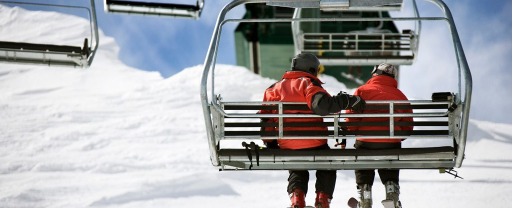 Couple sitting on ski lift together