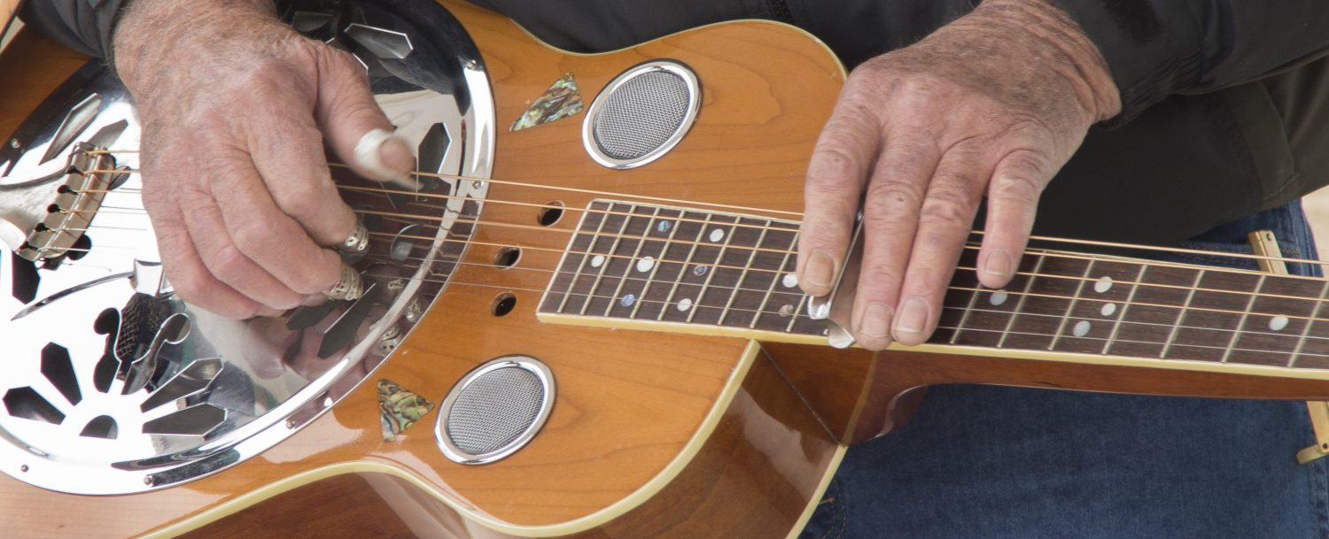 Close up of man strumming banjo