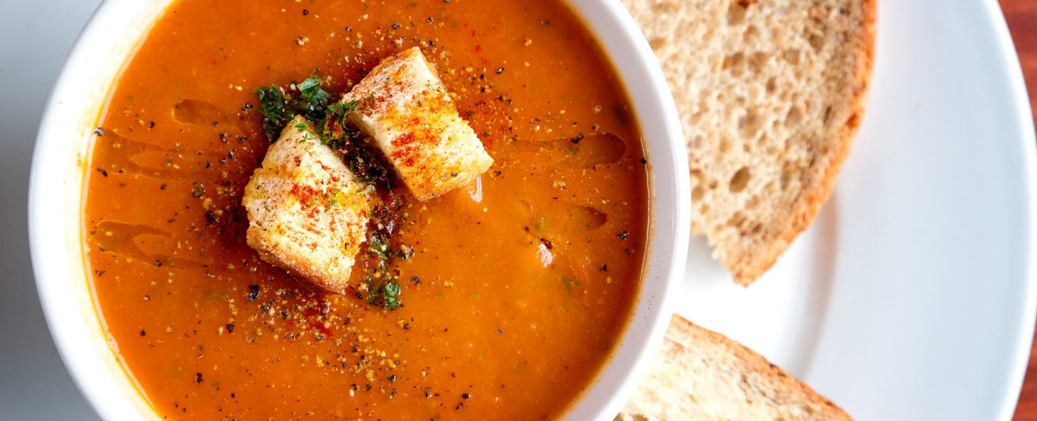 Close up of tomato soup with toasted croutons