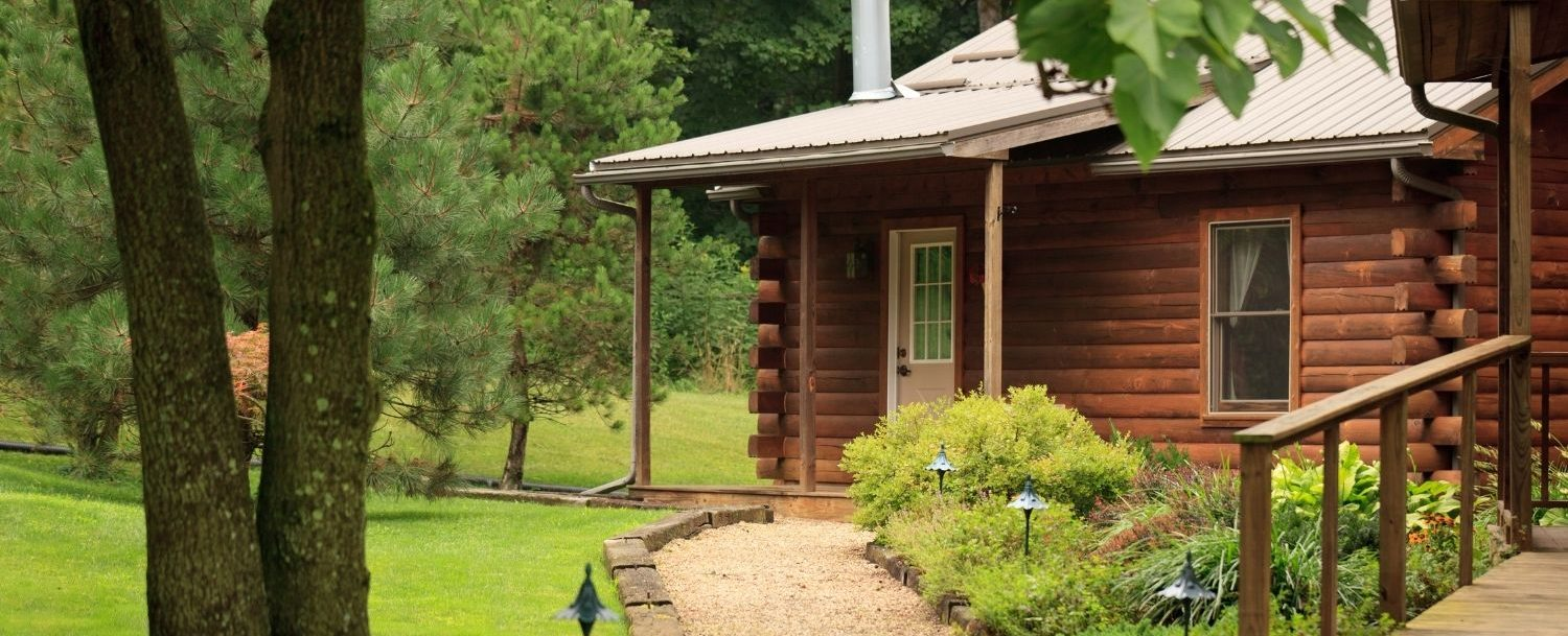 Exterior entrance to log cabin in summer time