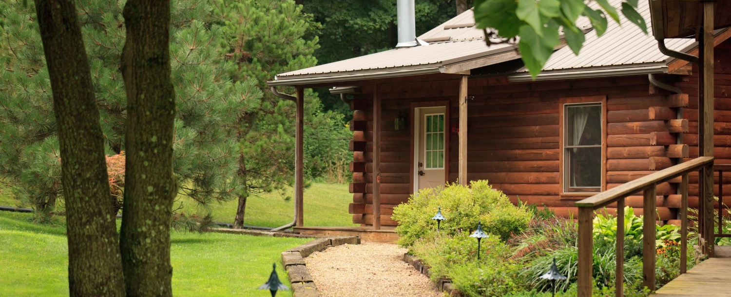 White Oak Inn log cabin exterior during the summer