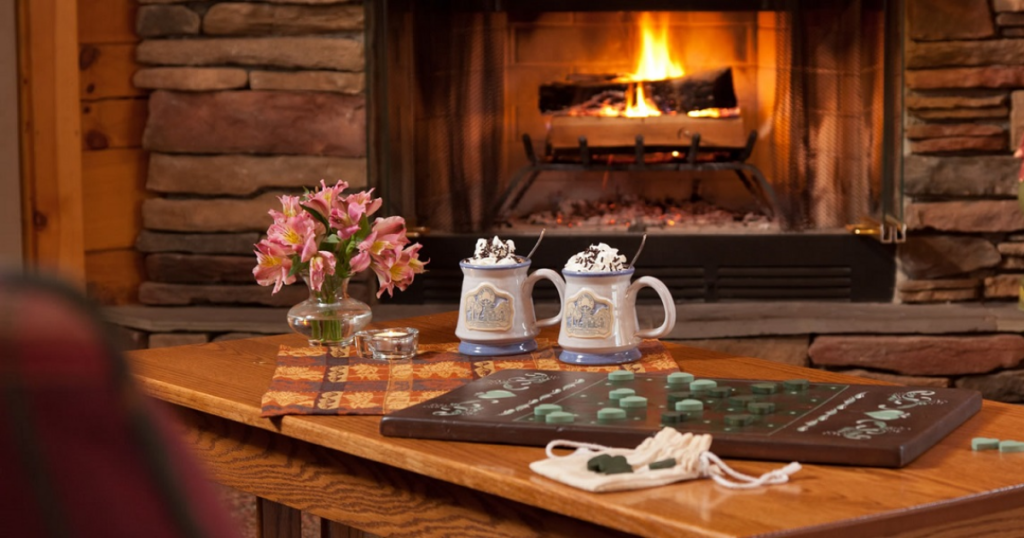 checker board and hot drinks in front of fireplace