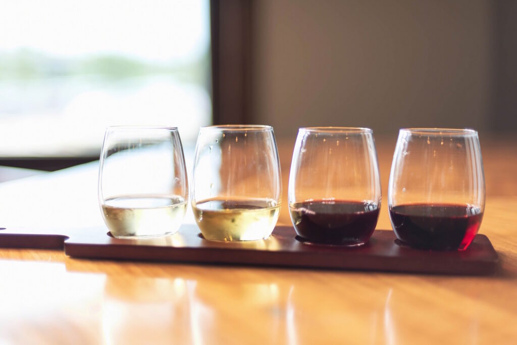 Wine glasses on a flight at a winery.