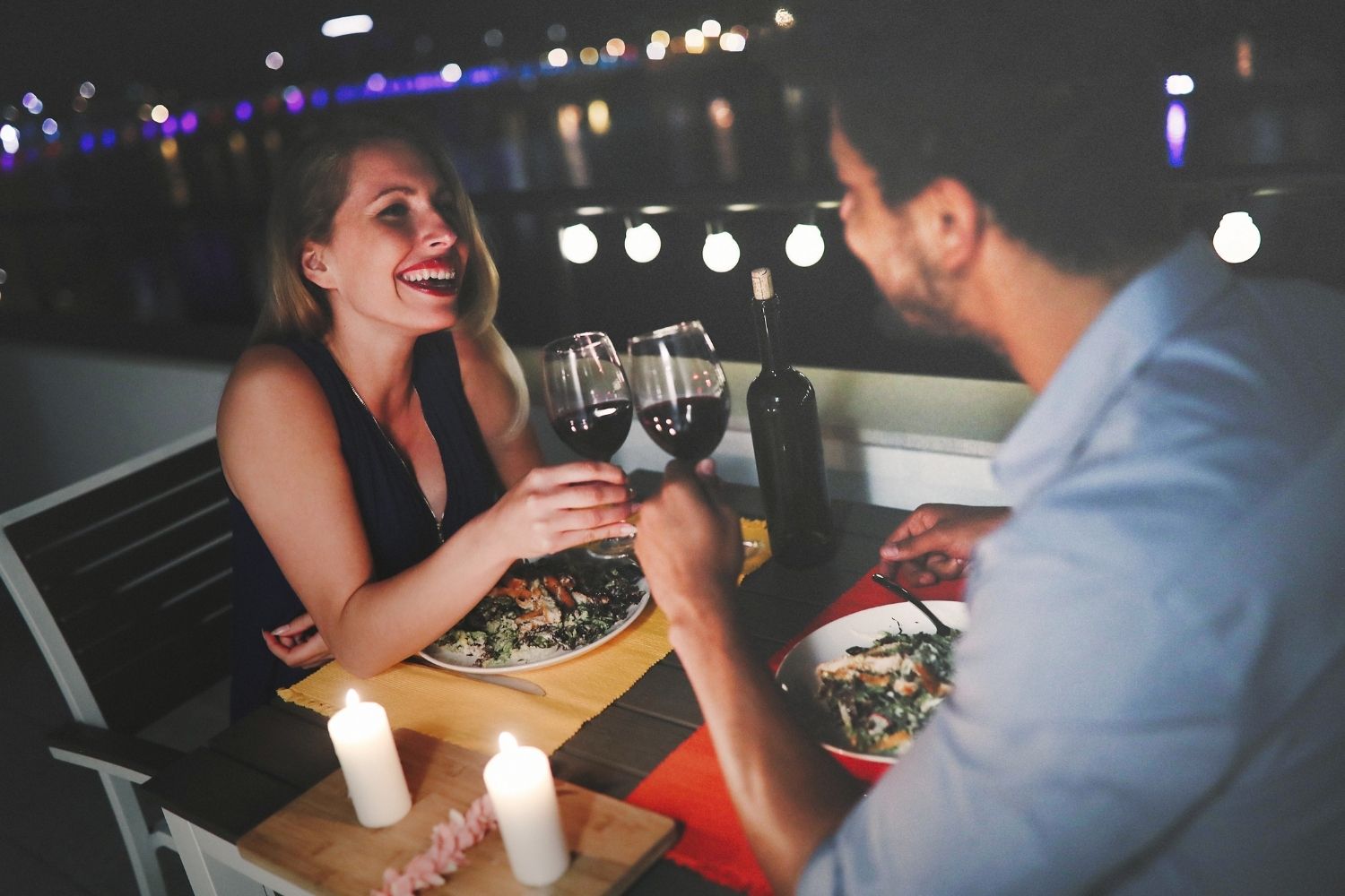 Couple dining at a waterfront restaurant.