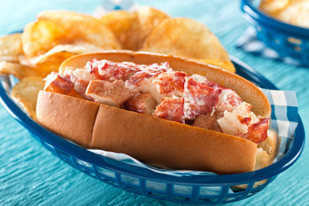 Lobster roll and chips in a basket.