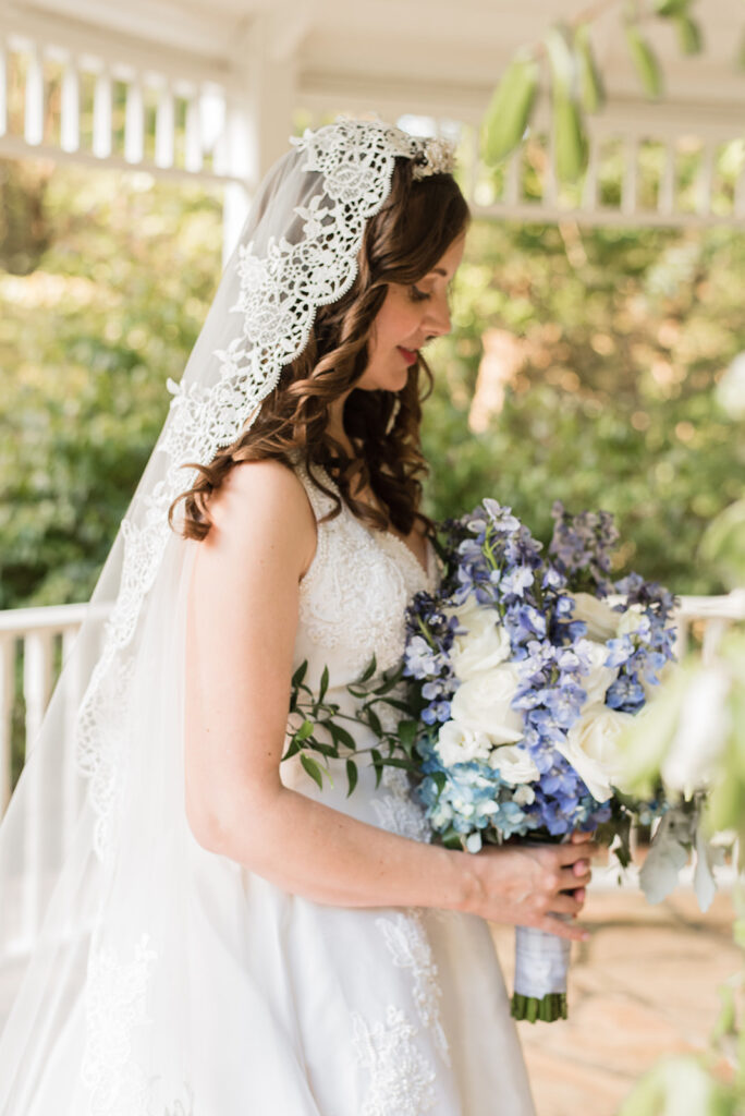 Bride Looking at Flowers on Arrowhead Porch