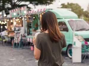 Woman walks around a food truck park