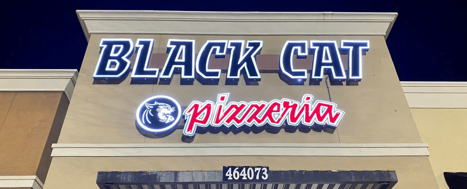 Black Cat Pizzeria signage at night