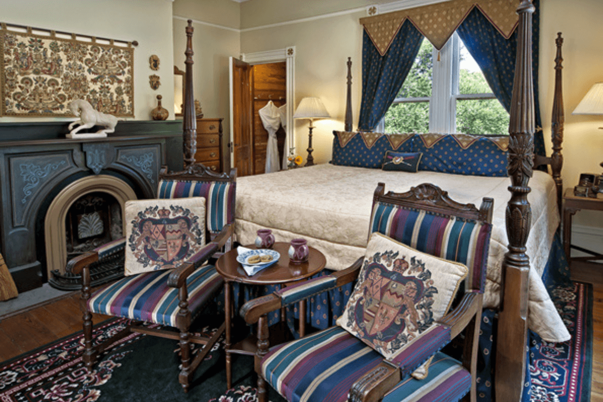 Captains Room Bedroom with Fireplace, chairs, and bed