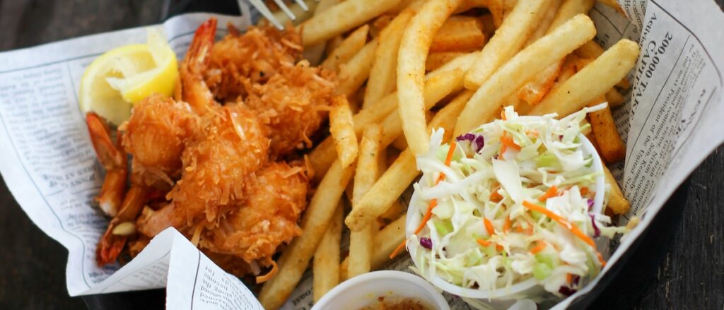 fried shrimp and fries on a platter at a tavern style restaurant