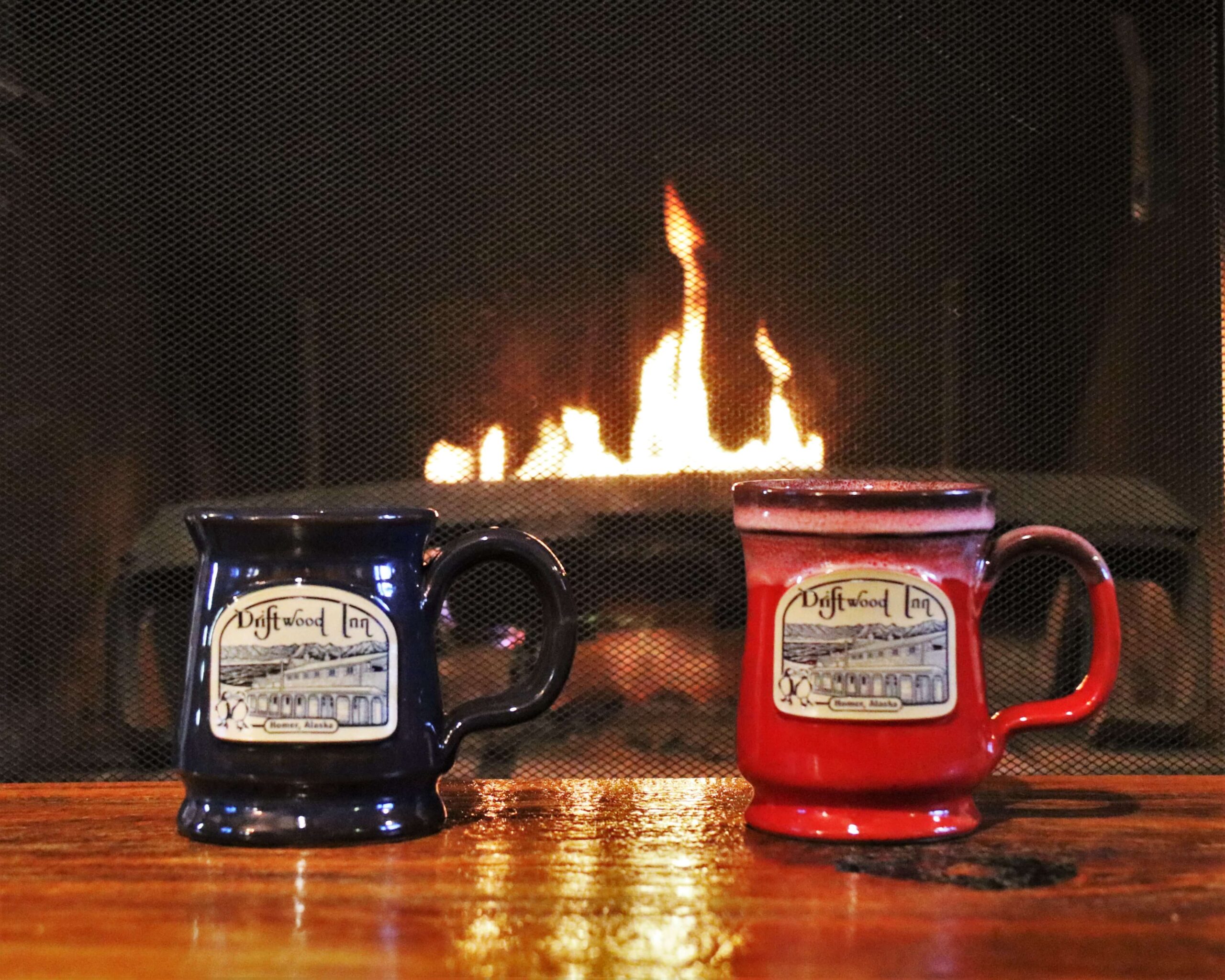 red and blue mugs sitting on table in front of fireplace