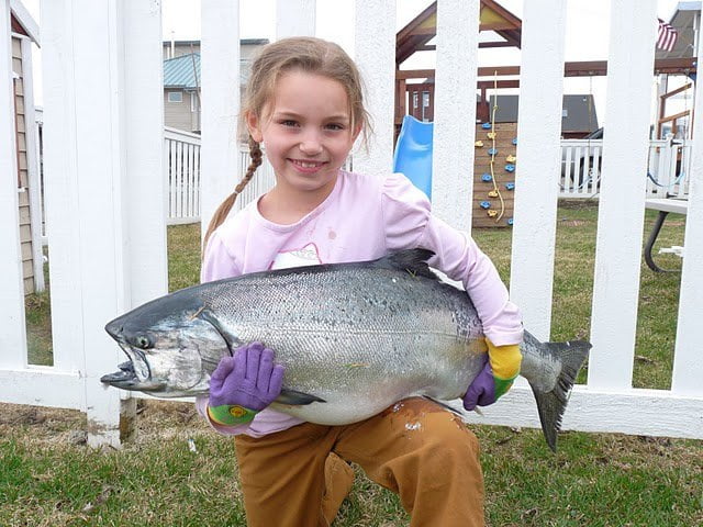 little girl holding fish
