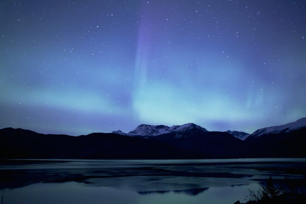 Northern lights (Aurora Borealis) over the mountains near Haines Alaska.