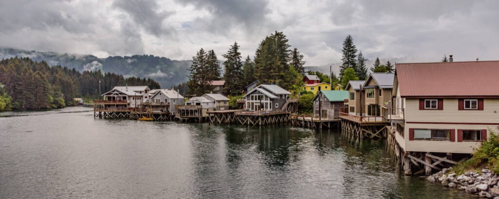 Cloudy day on Seldovia with a lake in the forground surrounded by homes and trees