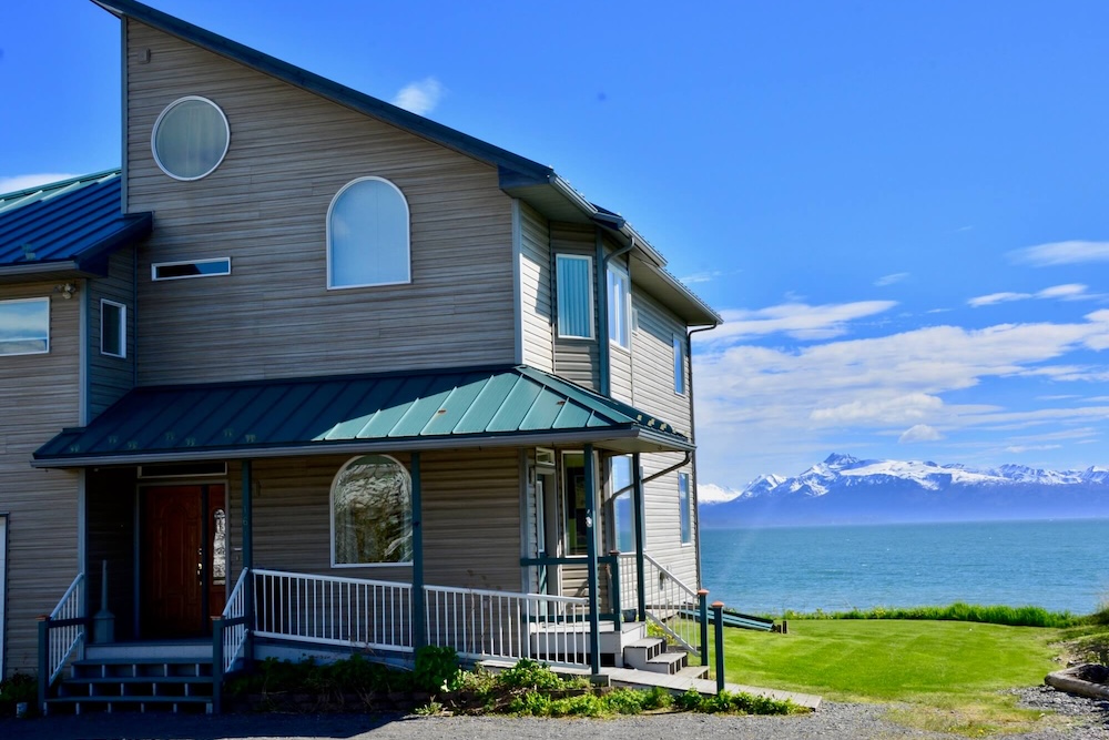 Vacation rental exterior with ocean and mountain views in background