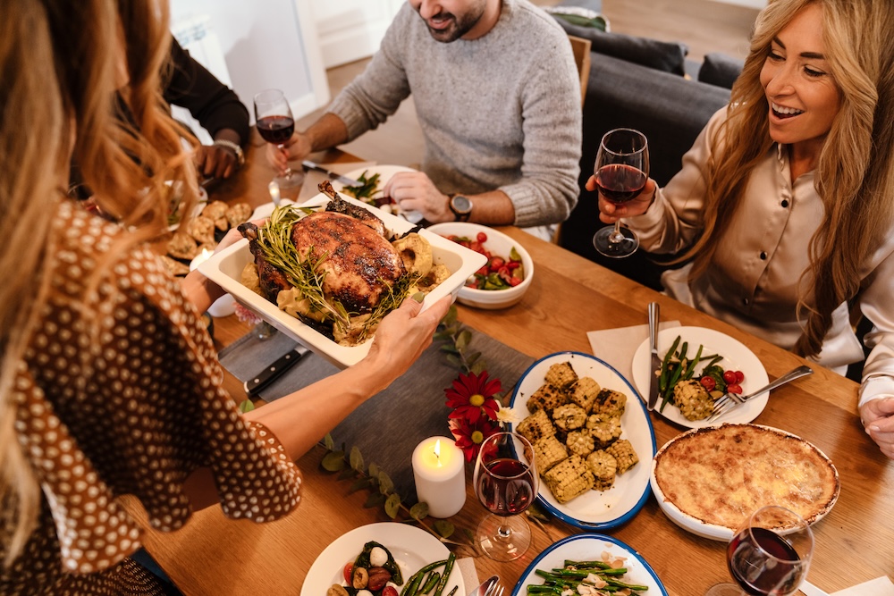 A group of people eating Thanksgiving dinner at a table