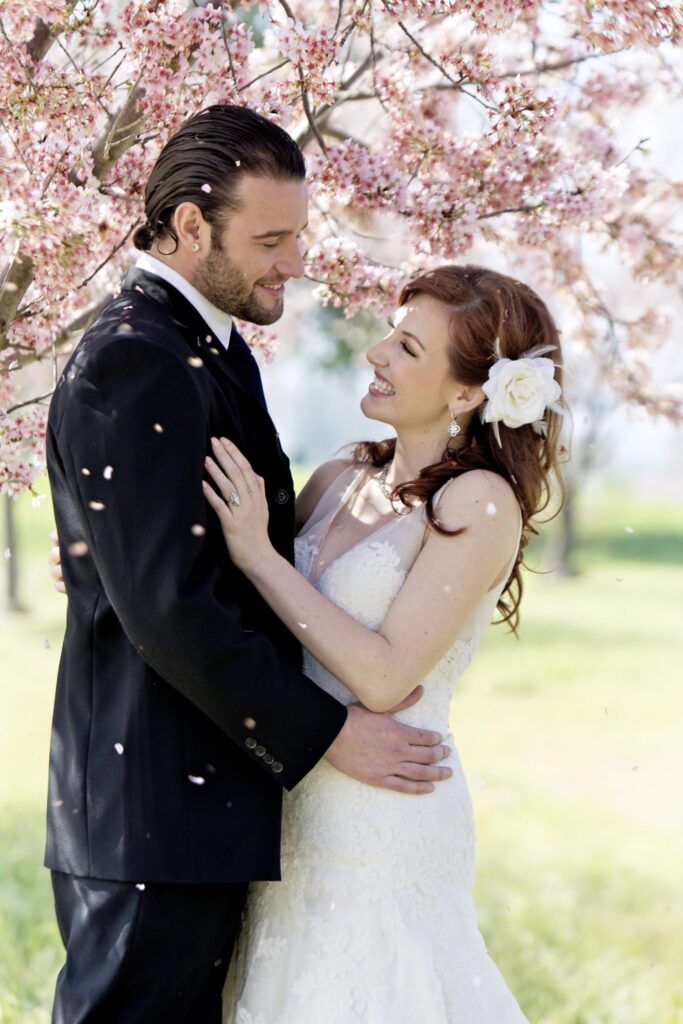 Couple's spring wedding under cherry blossom trees