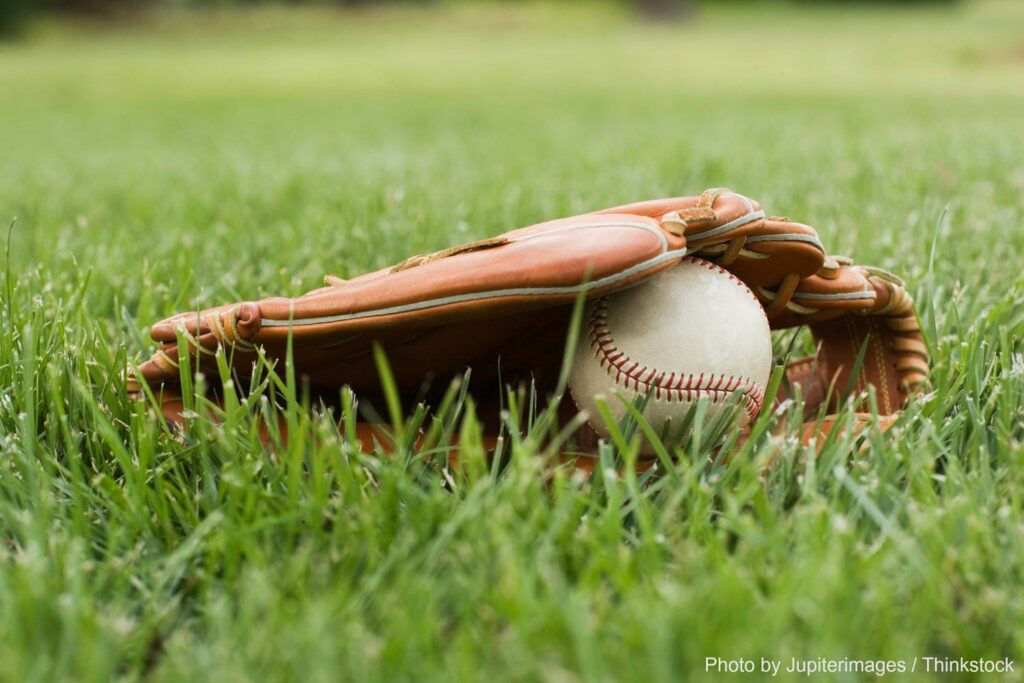 Baseball glove and ball in the grass at Coca-Cola Park